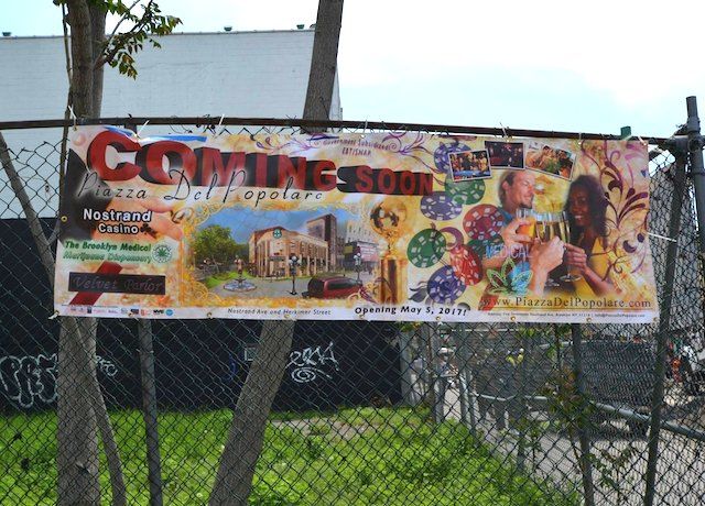 The banner hanging at the corner of Nostrand Avenue and Herkimer Street